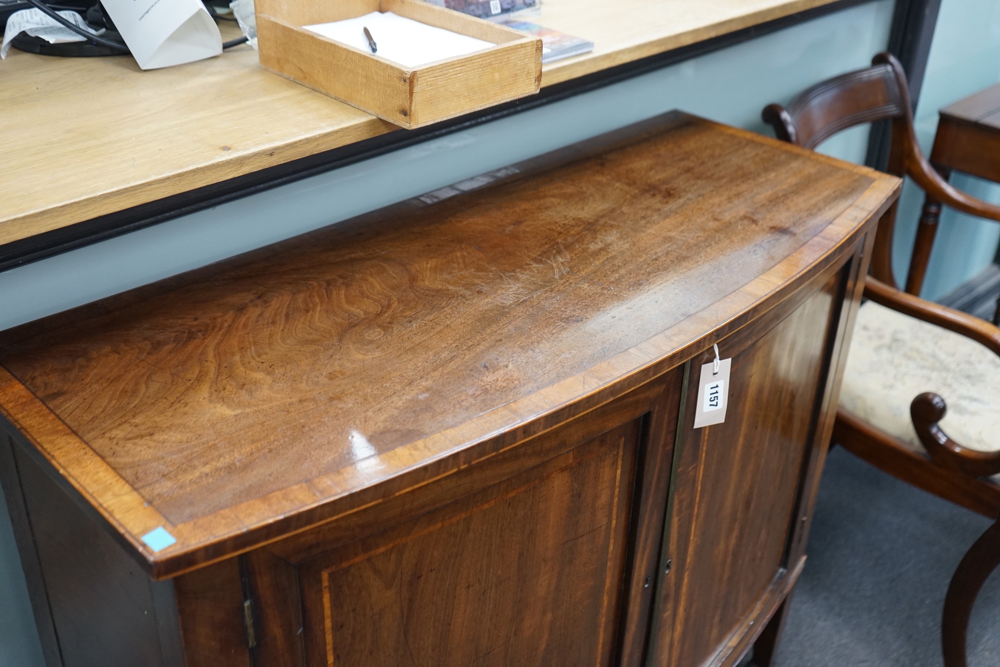 A George III mahogany and banded bowfront side cabinet with panelled doors on square tapering legs, width 103cm, depth 42cm, height 90cm